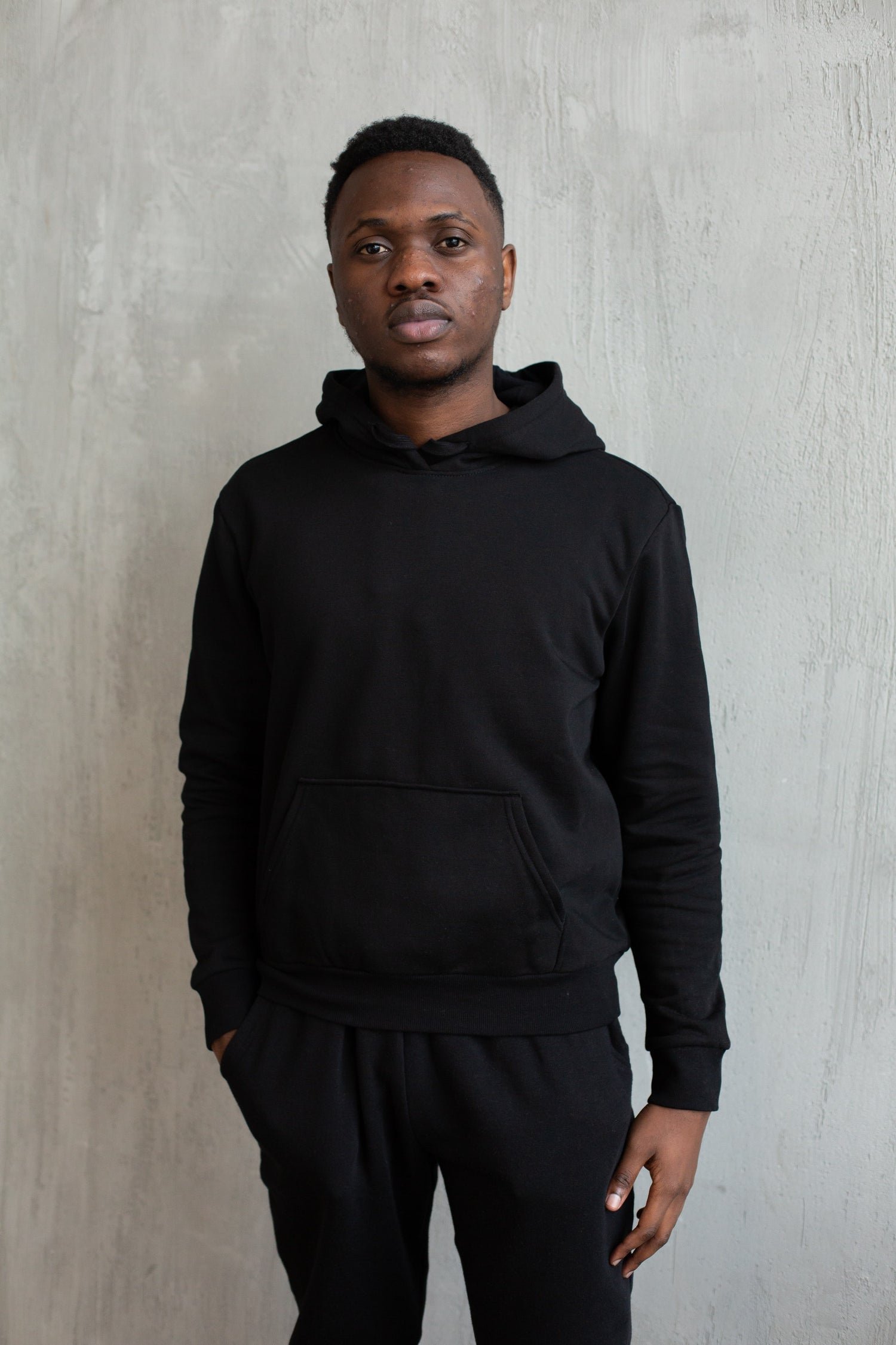 Man wearing a True Classic black pullover hoodie and Joggers