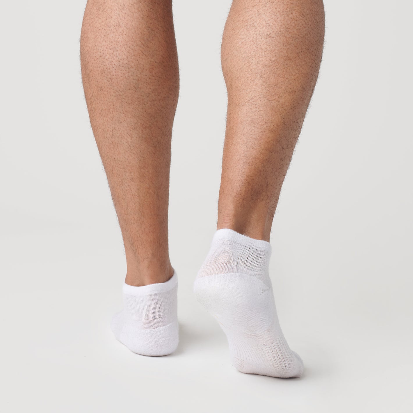 White Ankle Sock Single on feet, showcasing seamless toe and contour fit.