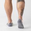 Person wearing Heather Gray Never Show Socks, displaying calf tattoo.