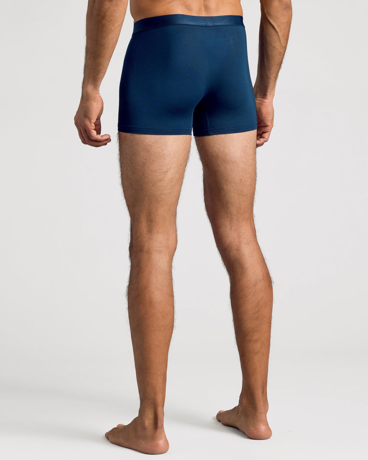 Navy Boxer Trunks W/ Fly 3-Pack worn by standing man, rear view.