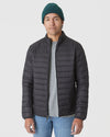 Man wearing Evergreen Sweater Beanie with black quilted jacket.