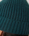 Evergreen Sweater Beanie in dark teal, showcasing its ribbed knit texture.