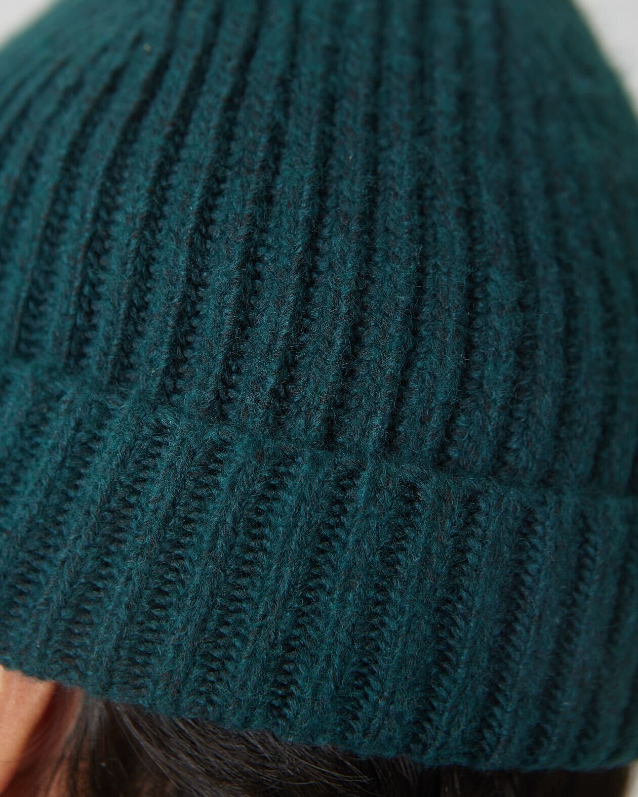 Evergreen Sweater Beanie in dark teal, showcasing its ribbed knit texture.