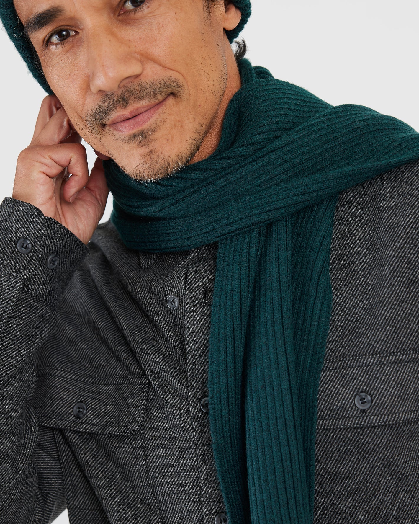 Man wearing Evergreen Sweater Scarf, ribbed-knit, ultra-soft, with matching beanie.