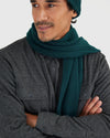 Man wearing Evergreen Sweater Scarf, dark charcoal-gray herringbone shirt.