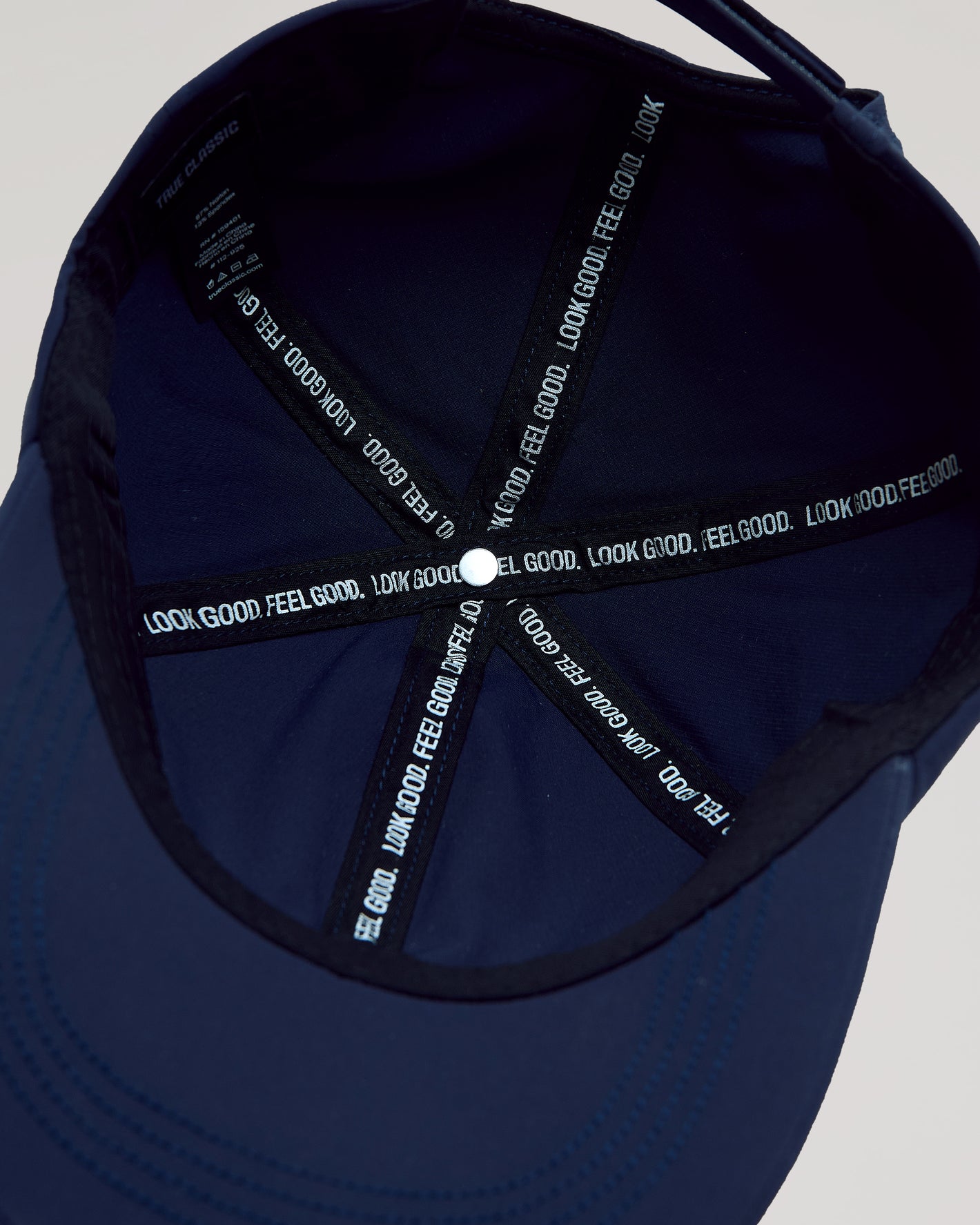 Interior of Navy Active Running Cap showing seam taping and fabric tag.