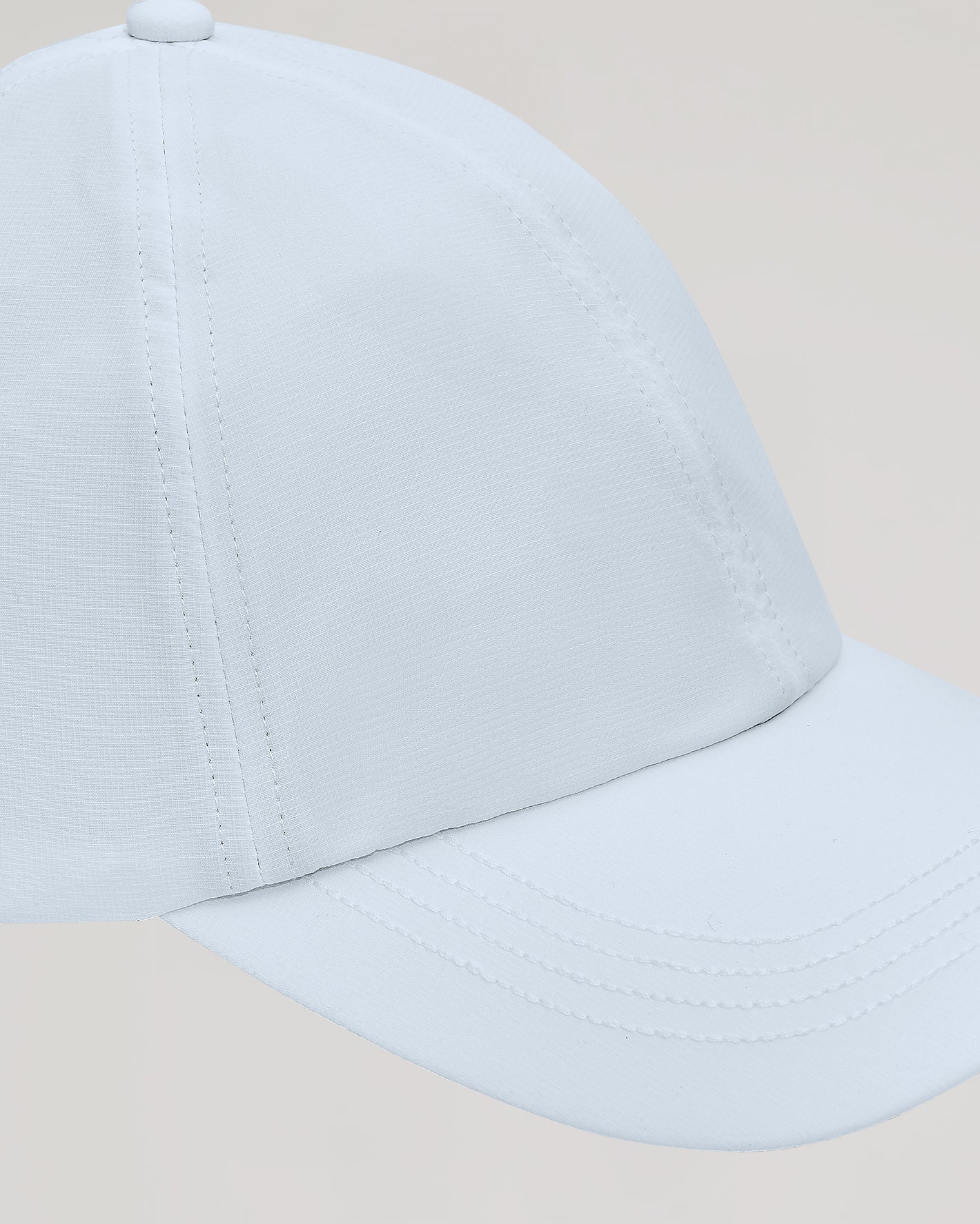 White Active Running Cap with curved brim, stitched crown panels, side view.