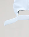 White Active Running Cap with adjustable Velcro strap, emphasizing its secure fit.