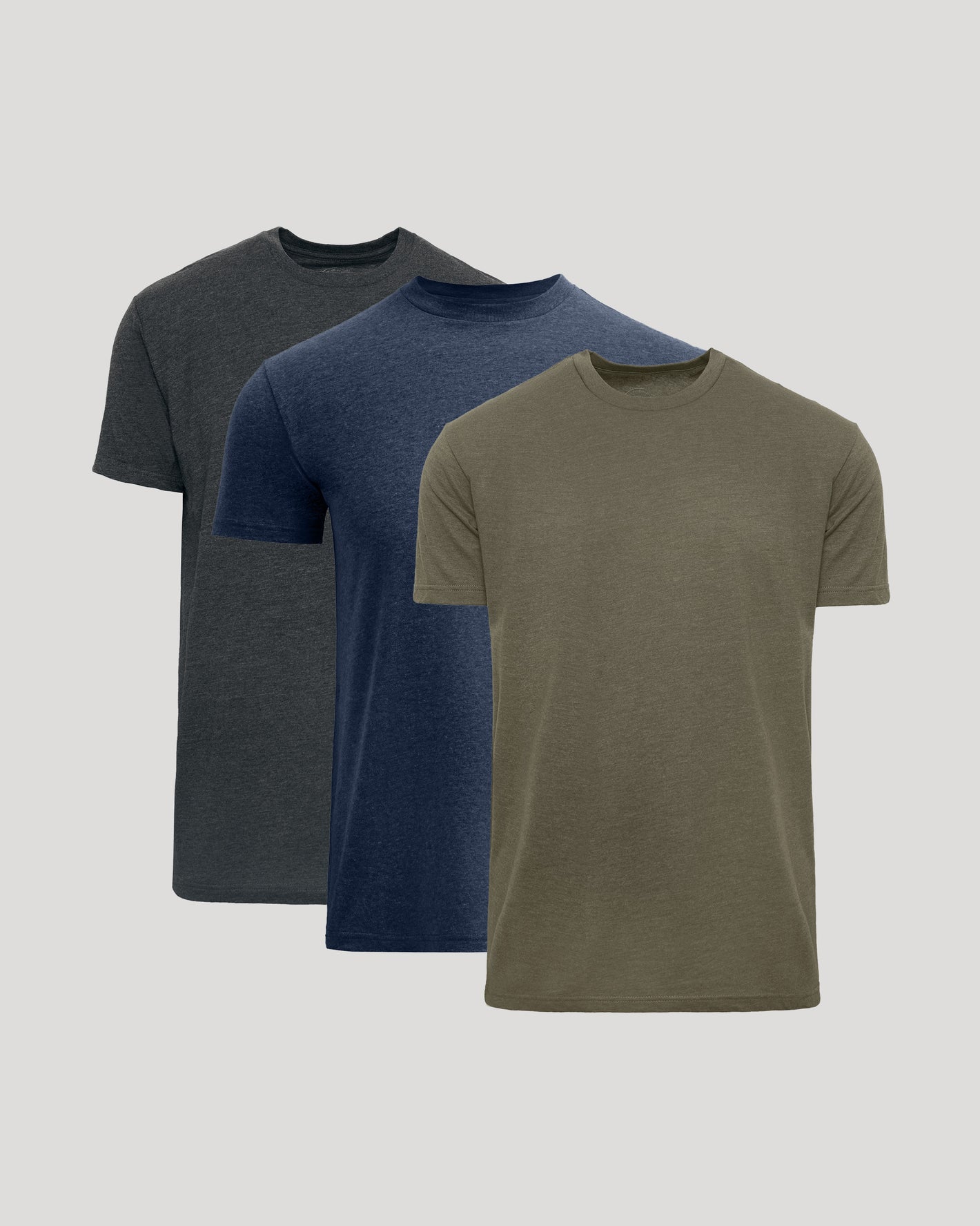Three short-sleeve crew-neck t-shirts in dark gray, navy blue, and olive green, arranged in a layered stack on a light gray background.