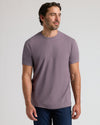 Man wearing Dark Heather Amethyst Classic Crew Neck, relaxed pose.