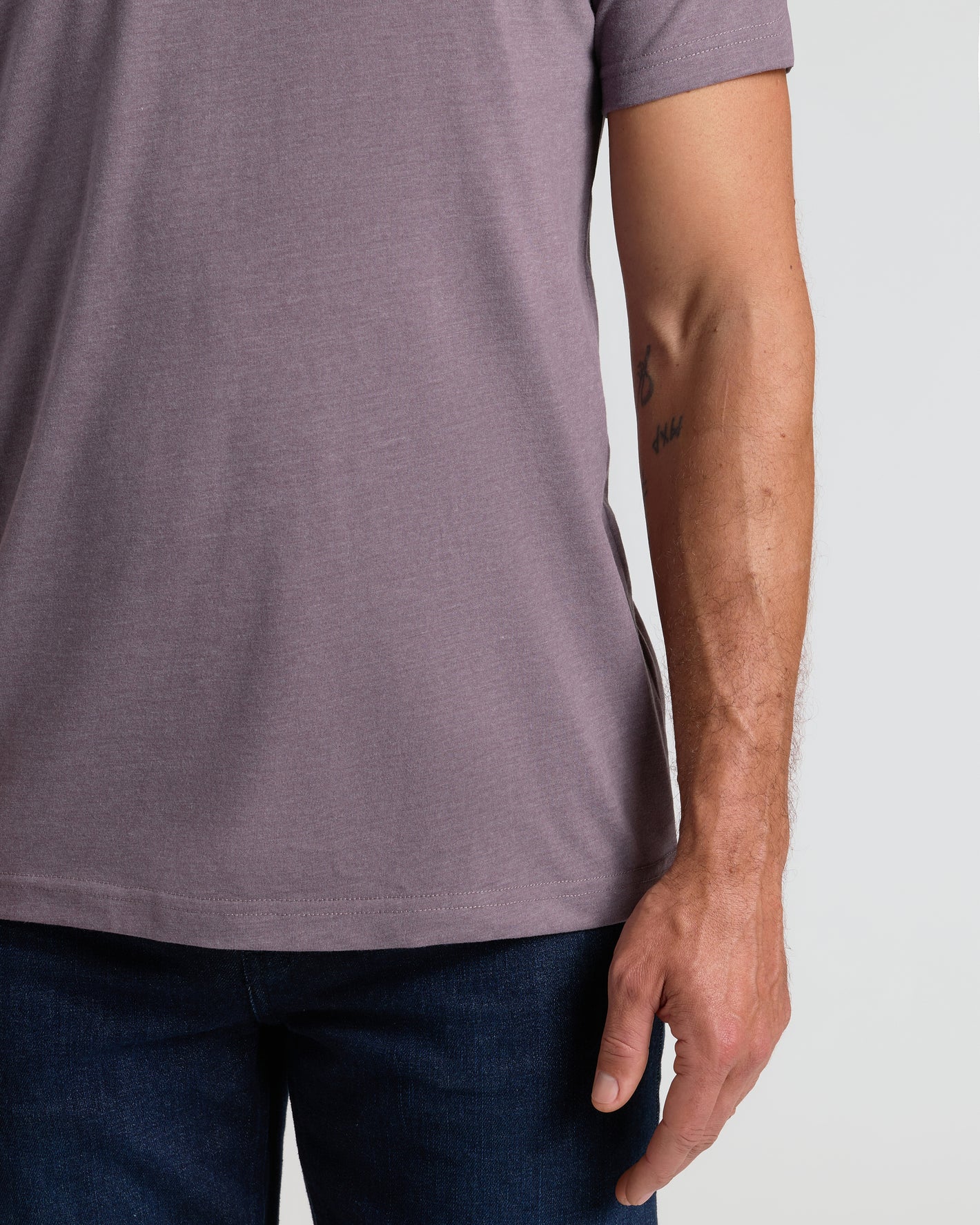 Dark Heather Amethyst Classic Crew Neck on person in jeans, tattoo visible.