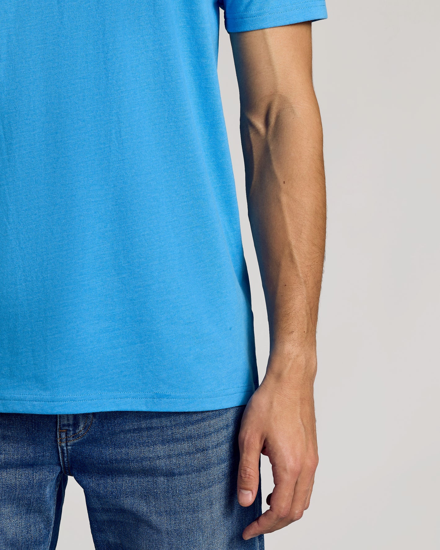 Dark Heather Bahama Blue Classic Crew Neck with blue jeans waistband visible.