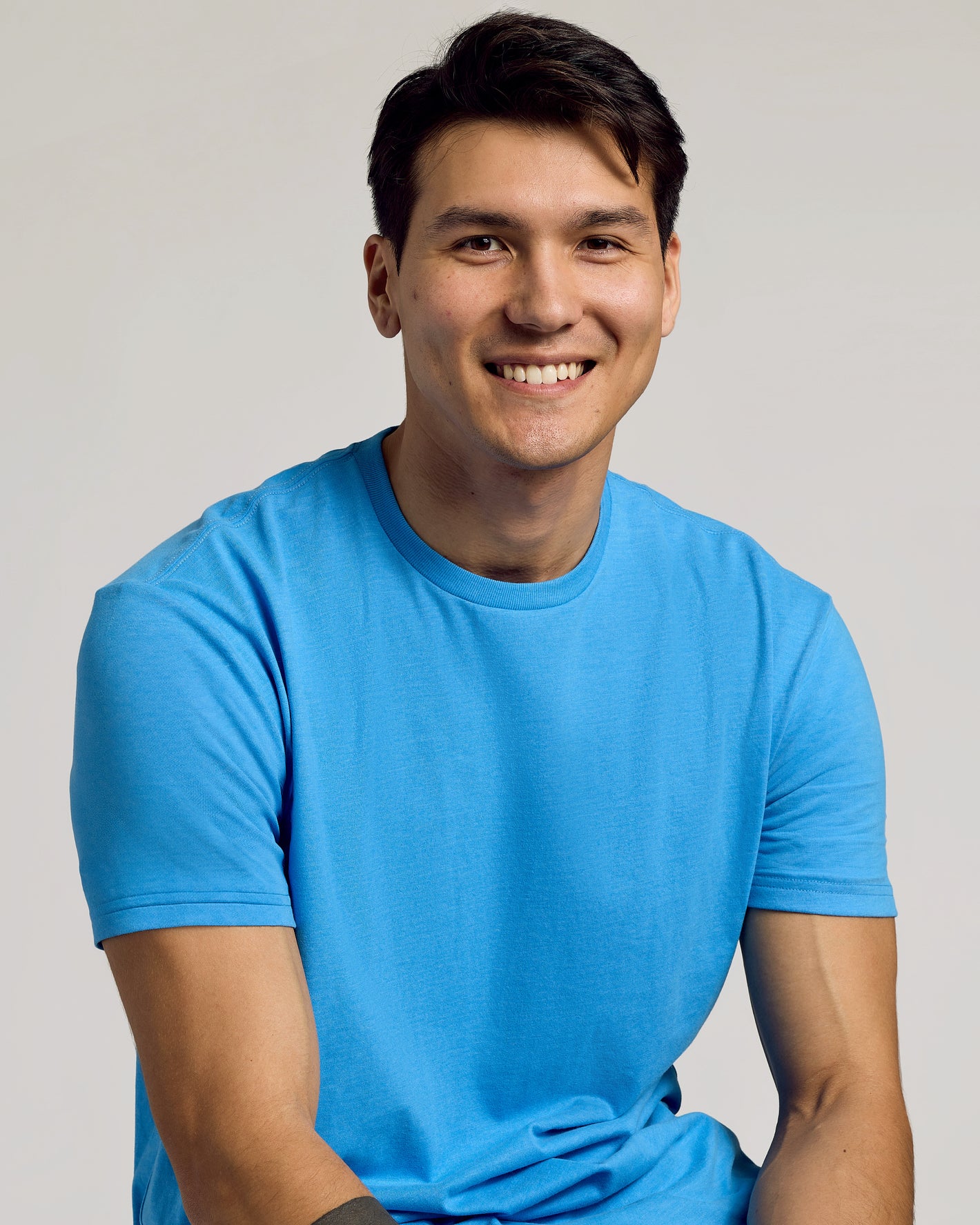 Young man in Dark Heather Bahama Blue Classic Crew Neck.