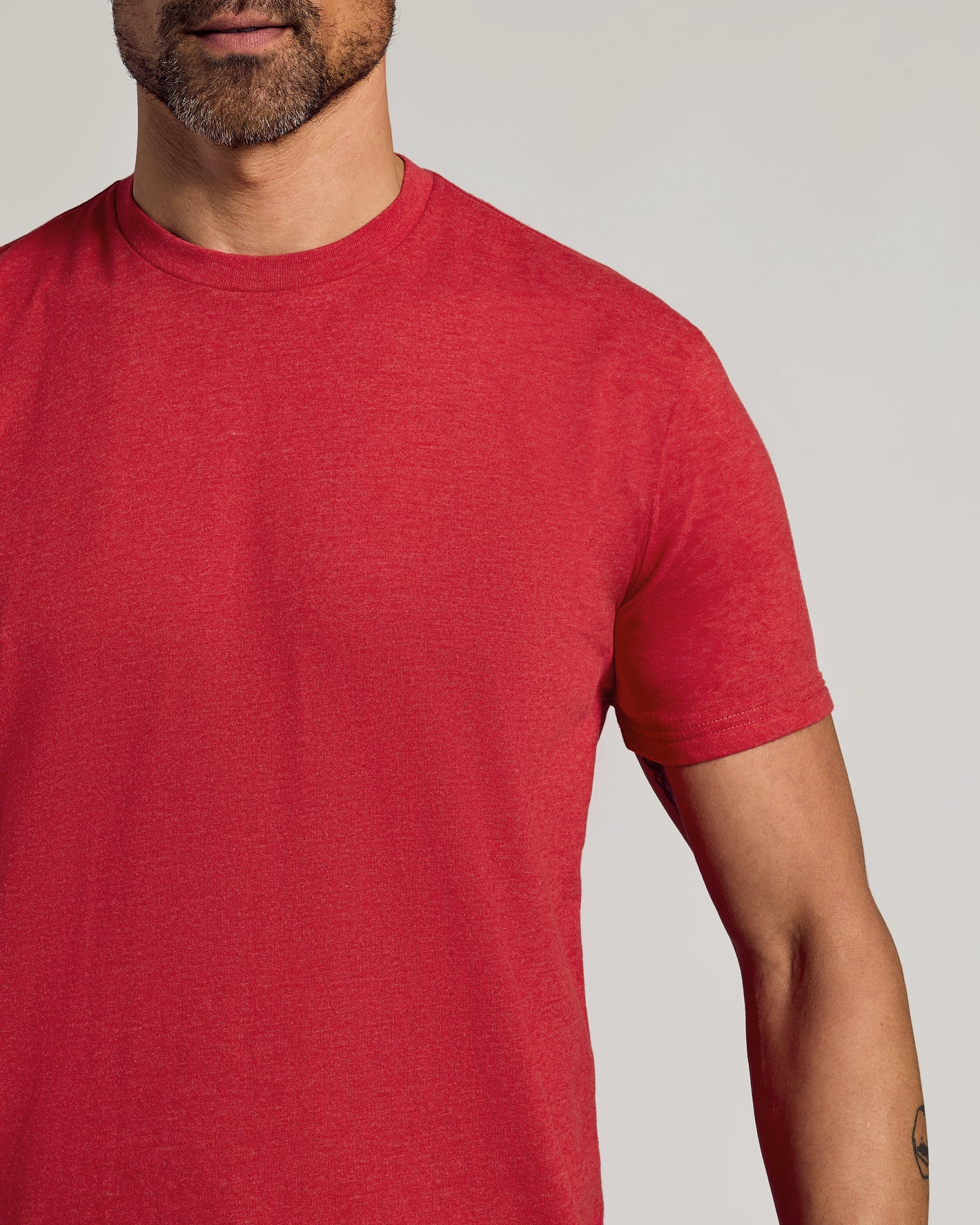Man wearing Dark Heather Lava Short Sleeve Crew Neck Tee.