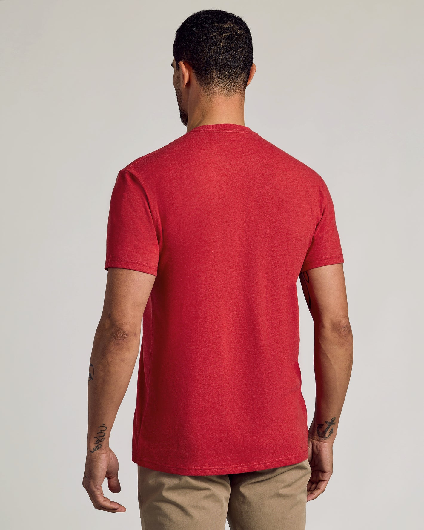 Man wearing Dark Heather Lava Short Sleeve Crew Neck Tee, showcasing back tattoos.