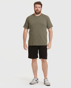 True ClassicMan wearing Classic Crews 6-Pack: olive-green T-shirt, black shorts, white sneakers.
