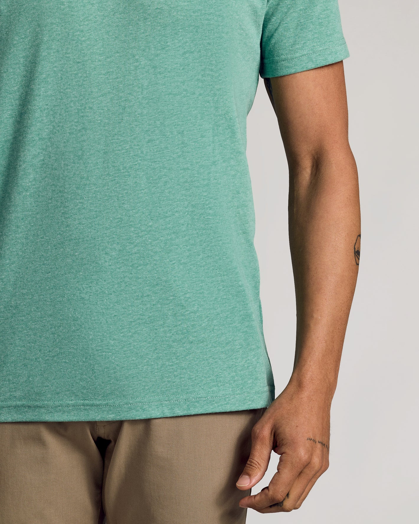 Light Heather Greenery Classic Crew Neck worn with khaki trousers.