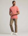 Man in Light Heather Vermilion Classic Crew Neck, khaki pants, white sneakers.