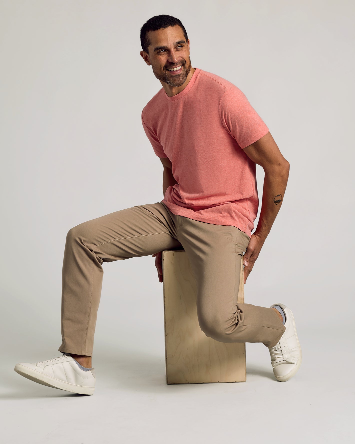 Man wearing Light Heather Vermilion Classic Crew Neck, slim-fit pants, sneakers.