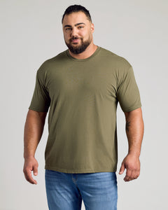 True ClassicMan wearing Woodland Shades Crew Neck T-shirt, olive-green, muscular build, smiling.