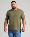 Man wearing Woodland Shades Crew Neck T-shirt, olive-green, muscular build, smiling.