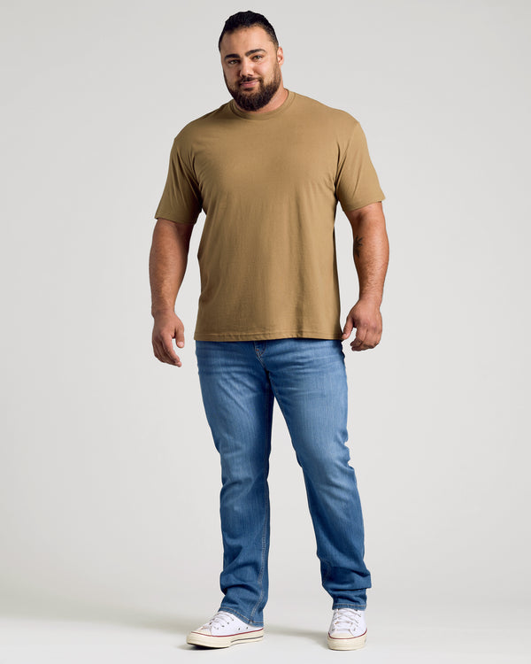 Man wearing Tan 499 Classic Crew Neck with jeans and sneakers.