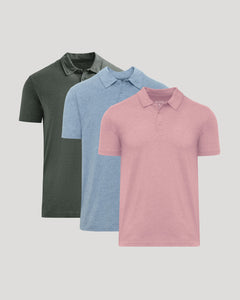 Three short-sleeve polo shirts shown in a layered arrangement on a light gray background: one dark olive green, one light blue, and one pink in front.