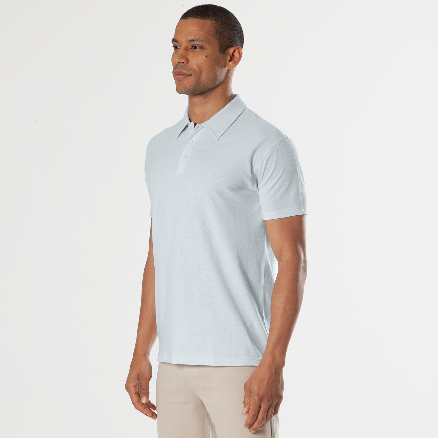 Blue Quartz Short Sleeve Polo on male model, paired with beige trousers.
