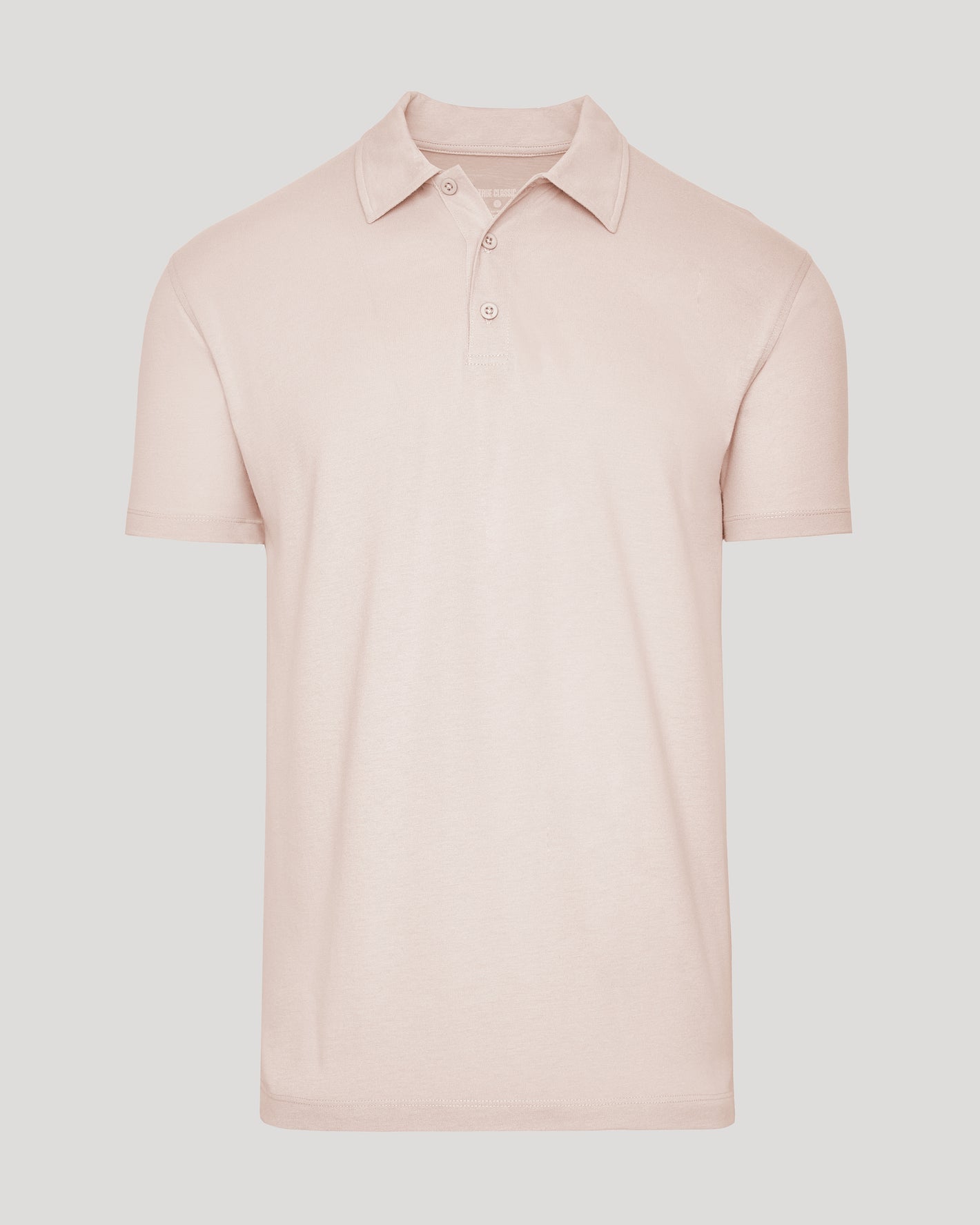 Coral Blush Classic Polo with ribbed collar and three-button placket.