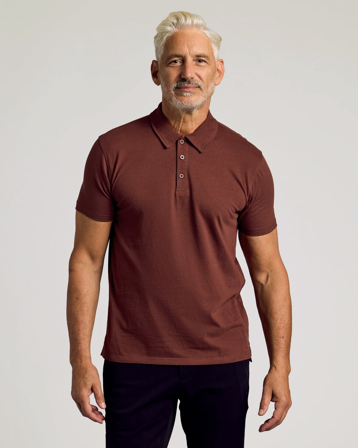 Man wearing Dark Chocolate Short Sleeve Polo with button placket.
