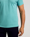 Man wearing Dark Heather Oceanic Classic Polo, showcasing its fitted design.