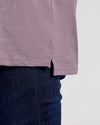 Dark Heather Amethyst Short Sleeve Polo hem over dark blue jeans.