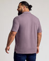 Back view of Dark Heather Amethyst Short Sleeve Polo on man.