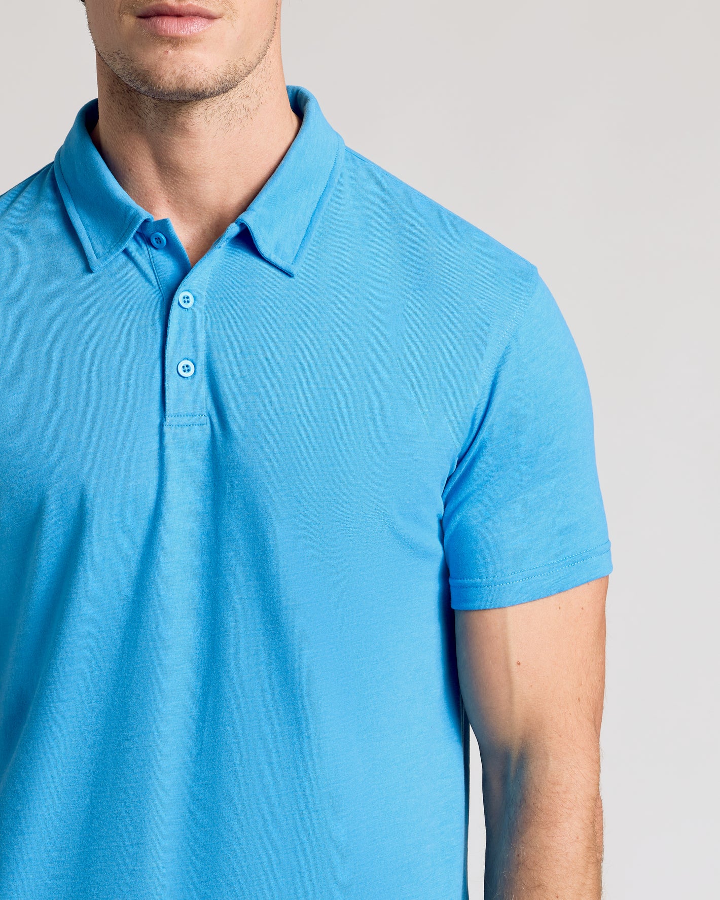 Dark Heather Bahama Blue Short Sleeve Polo with collar and button placket.