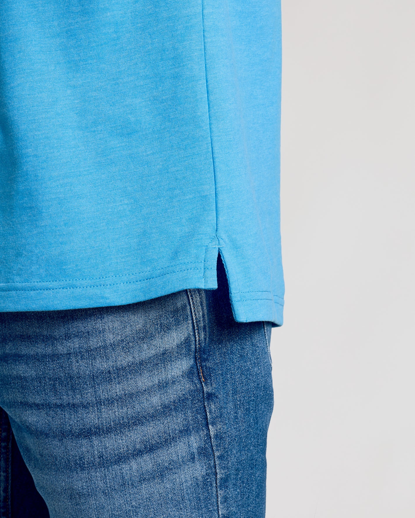 Dark Heather Bahama Blue Short Sleeve Polo over denim jeans.