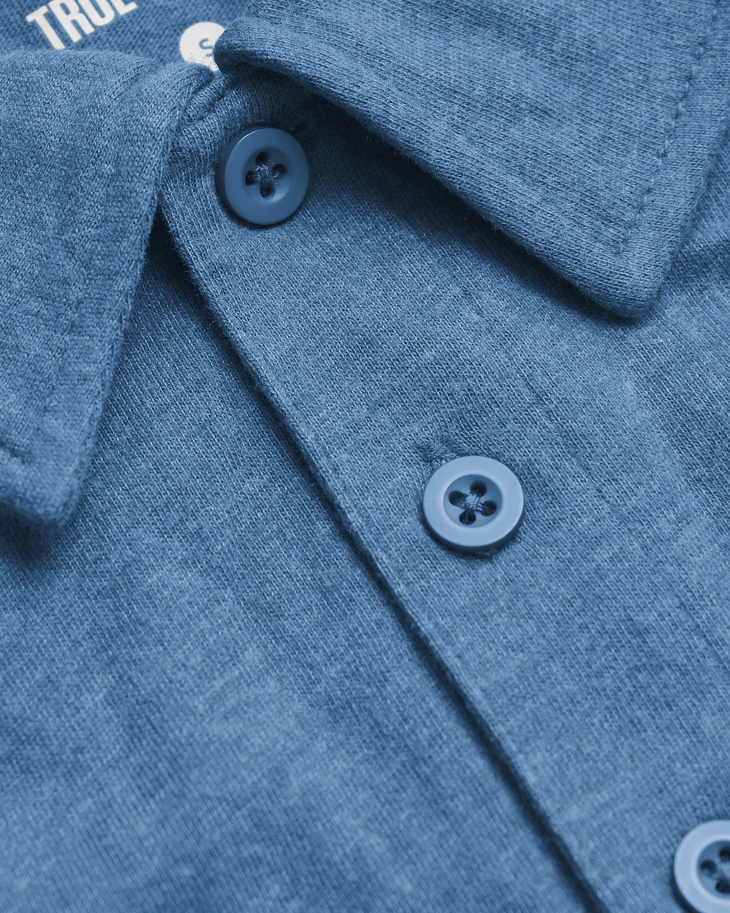 Close-up of Dark Heather Blue Lake Classic Polo, highlighting knit texture, collar, and buttons.