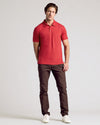 Model in Dark Heather Lava Short Sleeve Polo with dark pants.