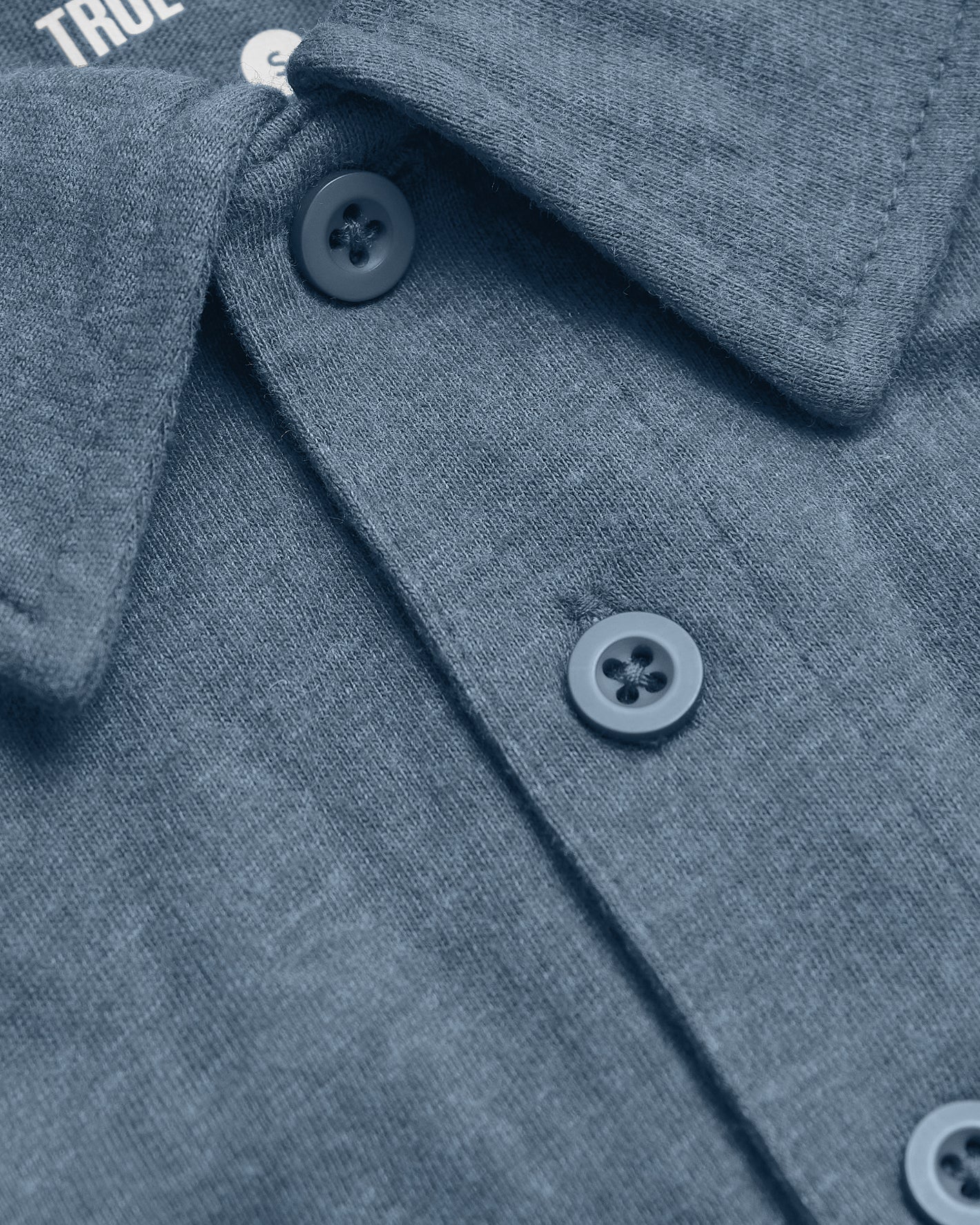Dark Heather Tempest Short Sleeve Polo, featuring a folded collar and buttons.