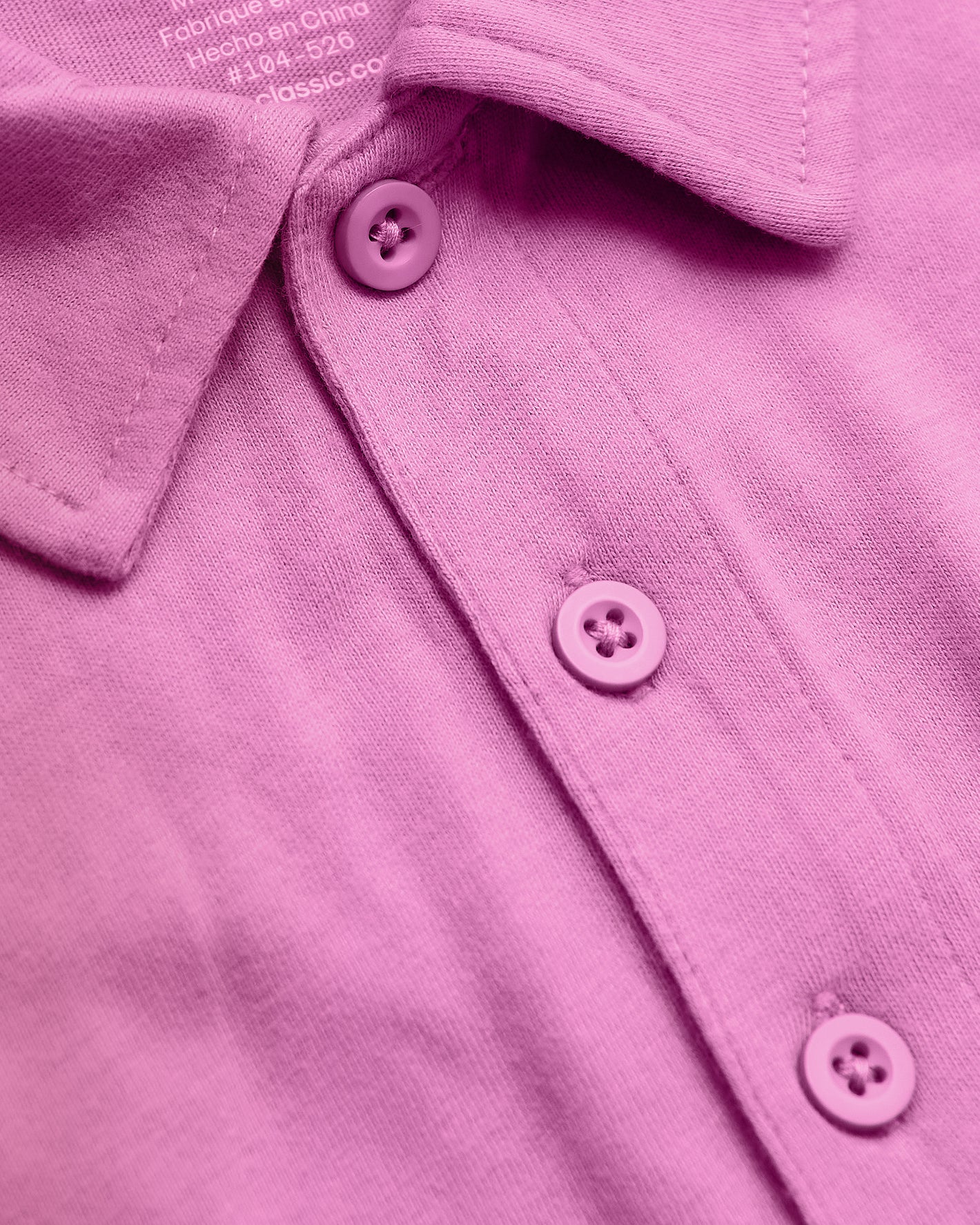 Heather Magenta Classic Polo with knit texture and three-button placket.
