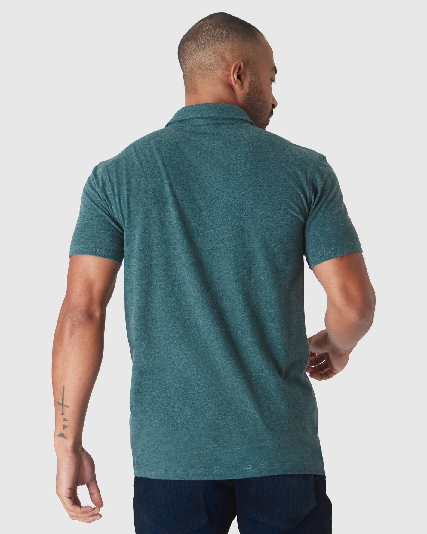 Man wearing Glacial Short Sleeve Polo, viewed from behind.