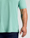Light Heather Greenery Classic Polo on person with palm-tree tattoo.