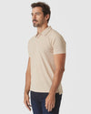 Light Camel Cream Heather Polo worn by model with dark indigo jeans.