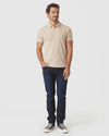 Light Camel Cream Heather Polo on man with slim-fit jeans and sneakers.