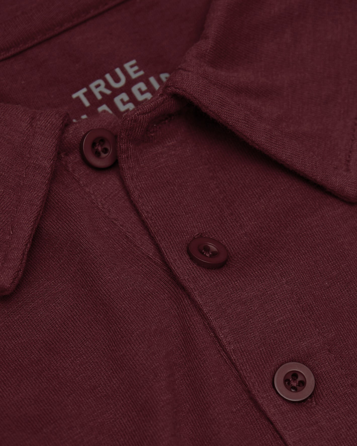 Mahogany Polo with knit texture and three-button placket.