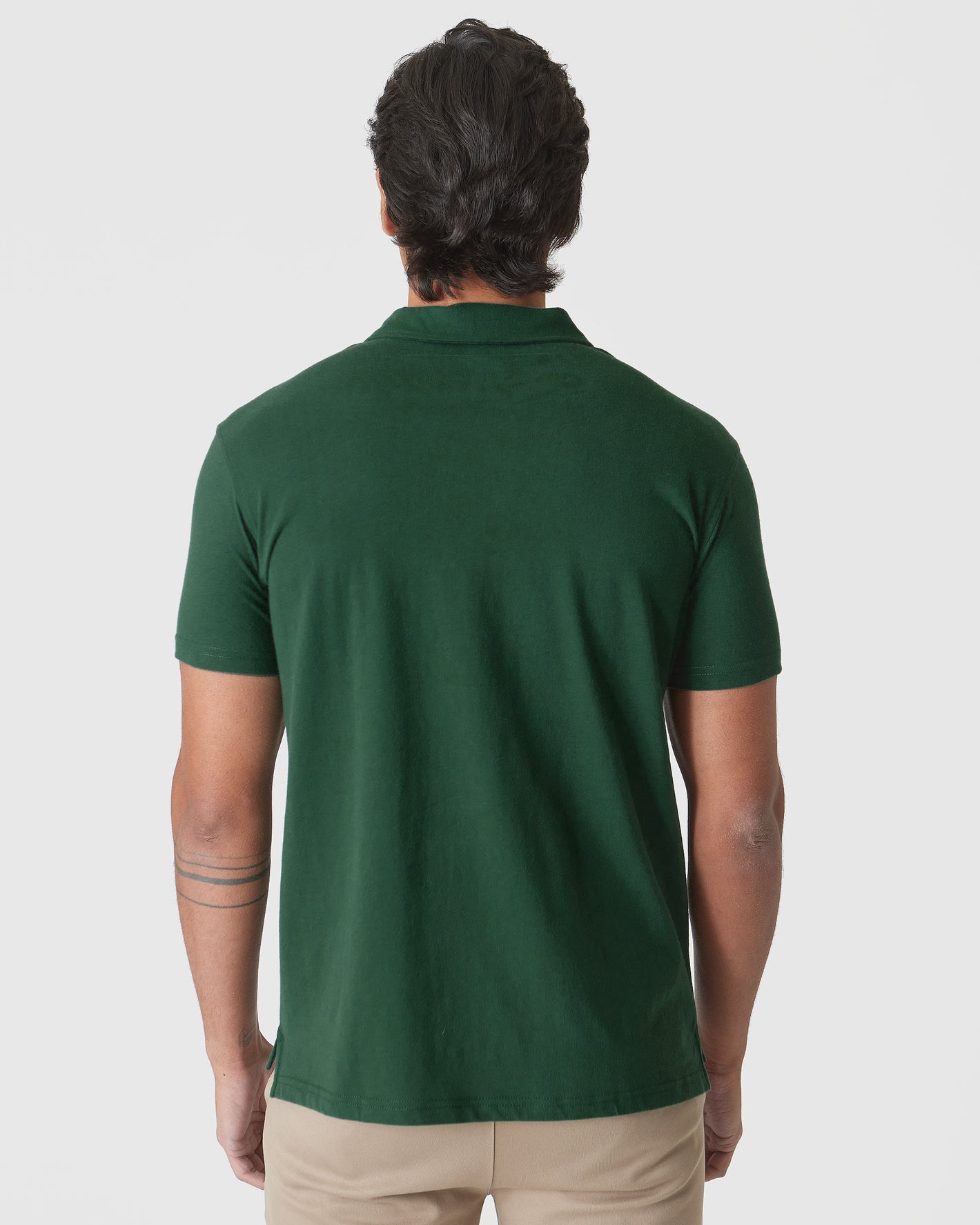 Back view of Moss Green Polo on model with tattoos.