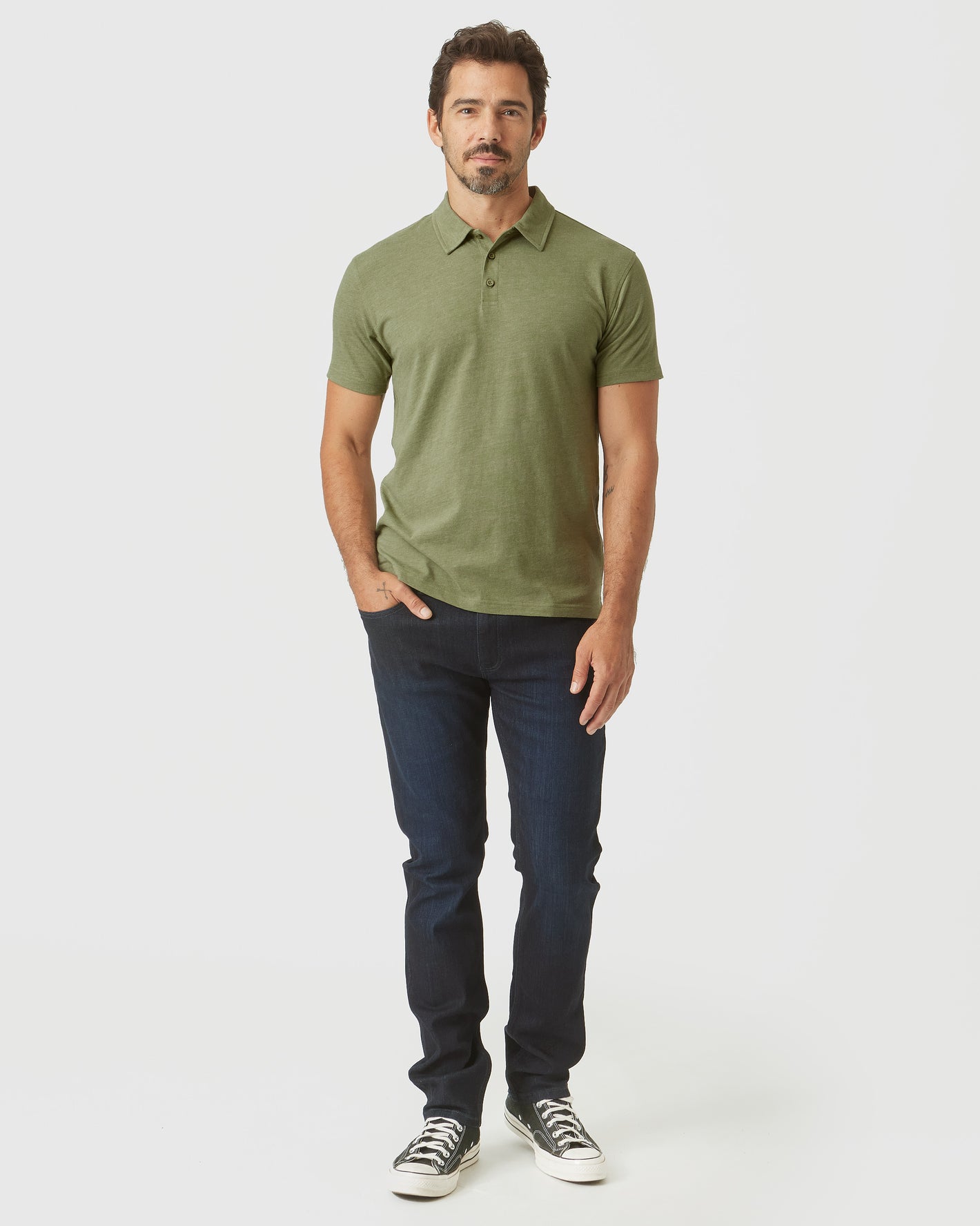 Man wearing Olive Green Heather Polo with jeans and sneakers.