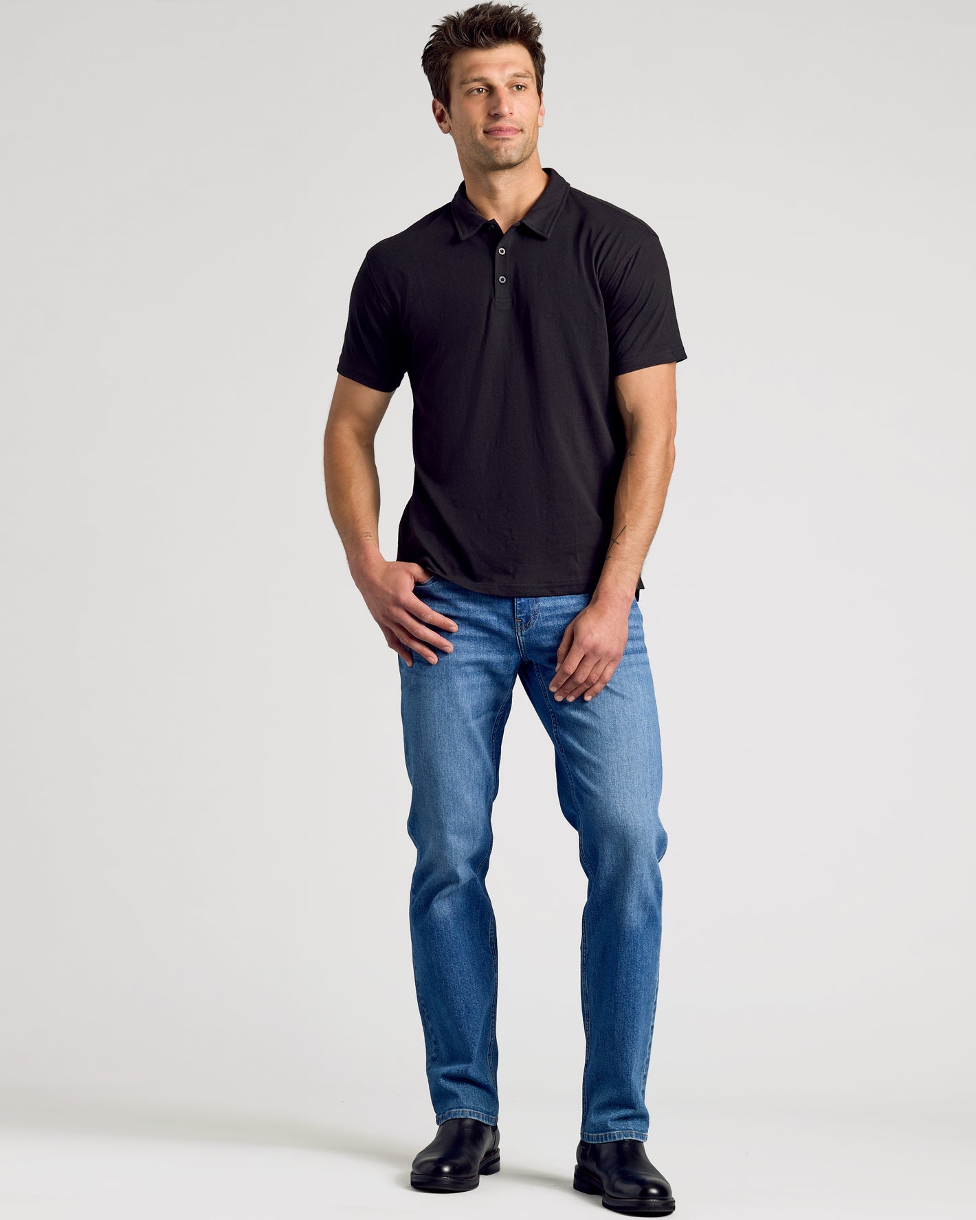 All Black Classic Polo 10-Pack styled with blue jeans and boots.