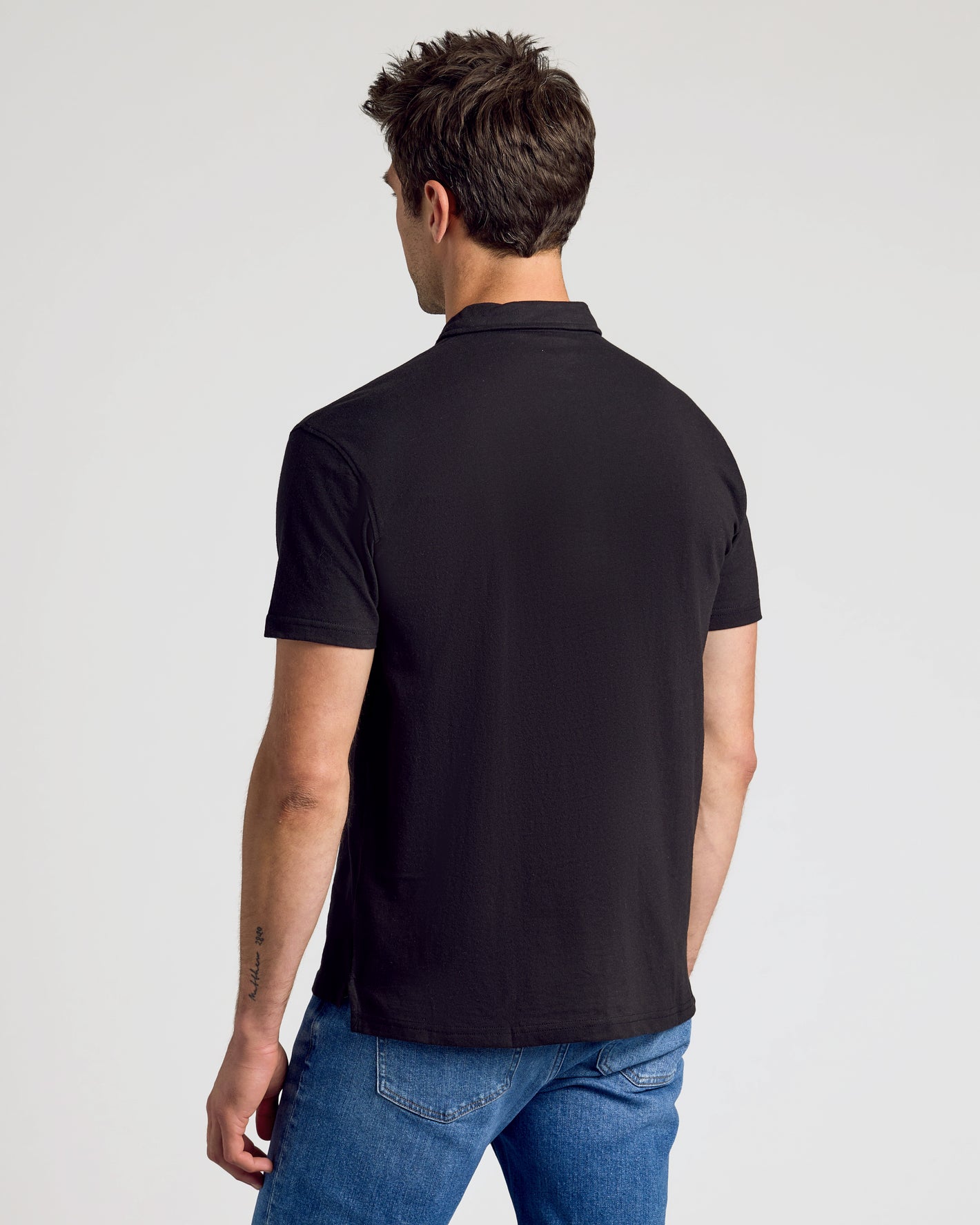 Rear view of man in the All Black Classic Polo.
