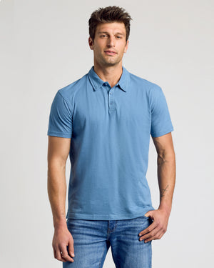 Man wearing Indigo Classic Polo and jeans, showcasing the polo's fit.