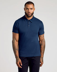 True ClassicMan wearing a navy blue polo shirt against a plain background